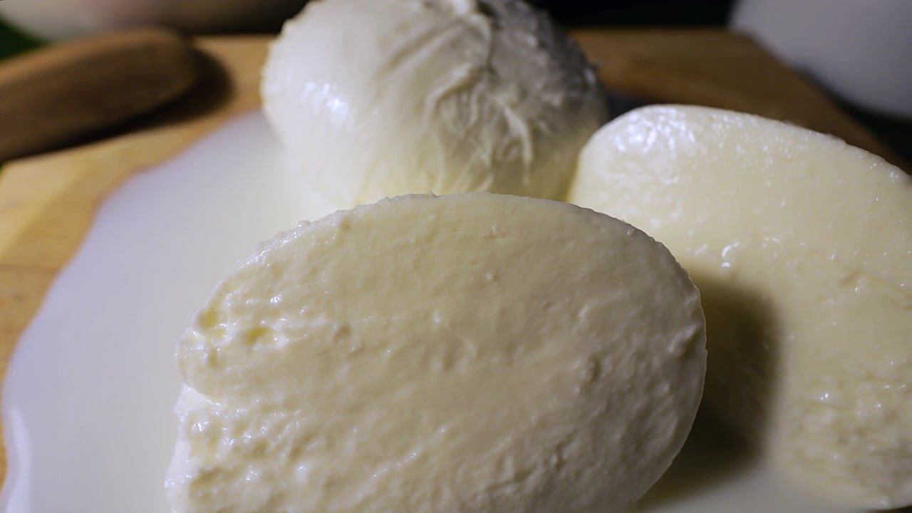 50p ekstremt nærbilde med slider-opptak som beveger seg over teksturen av fersk mozzarella.