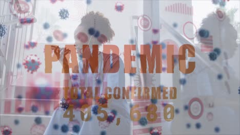 Animation-Einer-Insgesamt-Bestätigten-Pandemie-Und-Eines-Virus-über-Einem-Afroamerikanischen-Arzt-Mit-Smartphone