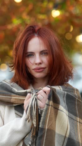 woman in a plaid scarf in autumn