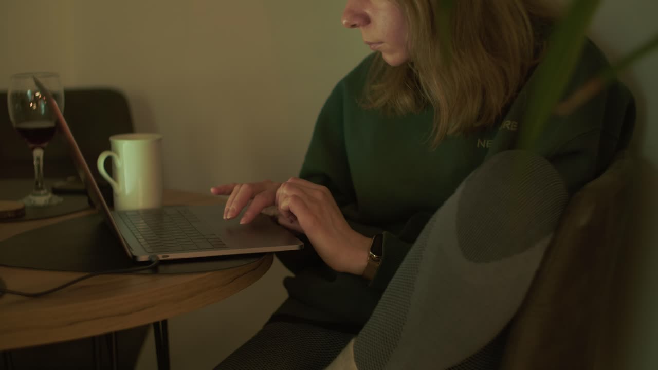 Woman working from home on laptop in cozy indoor workspace