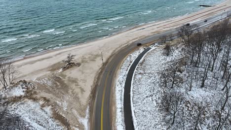 a coastal road covered in sand and snow