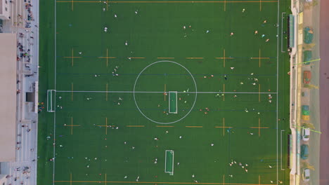 aerial green football field with training commands. top modern grass stadium