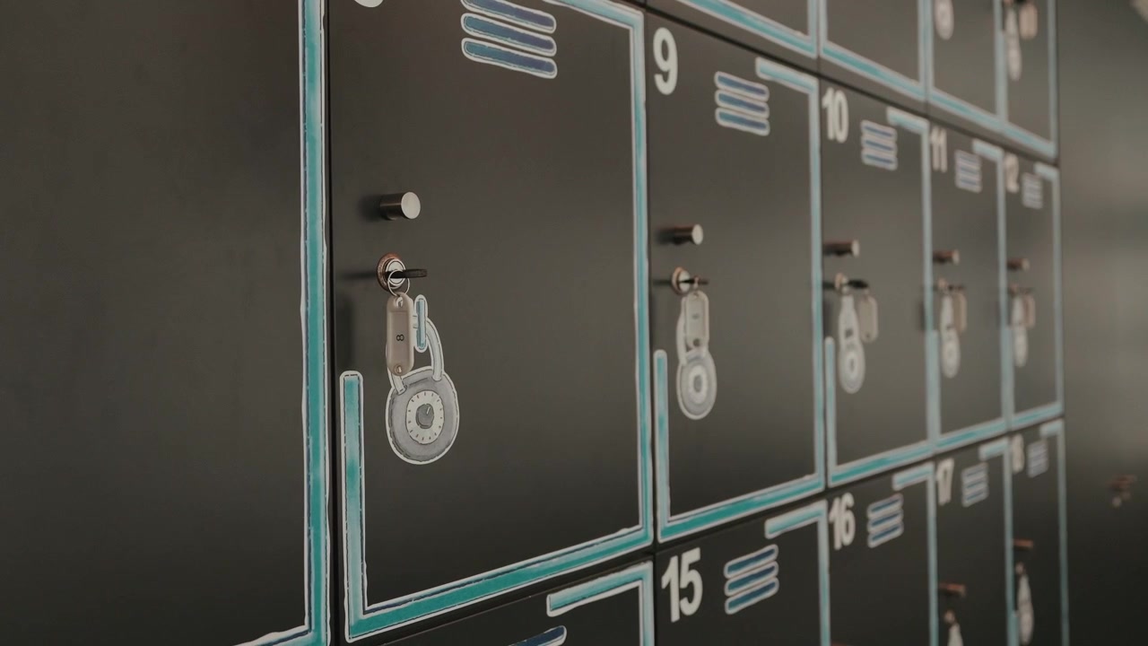 Row of numbered lockers with keys hanging in storage cabinet system