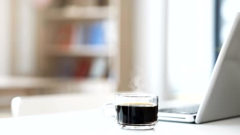 Cinemagraph of steaming coffee on working desk.