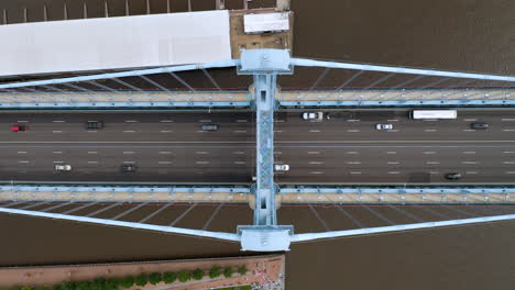 Aerial-overhead-view-of-Philadelphia-Ben-Franklin-Bridge-and-river-in-the-summer-with-cars-and-traffic-driving-on-the-road
