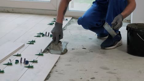 installing ceramic floor tiles - measuring and cutting the pieces. construction, renovation, repair apartment. cuts tile. tile cutting