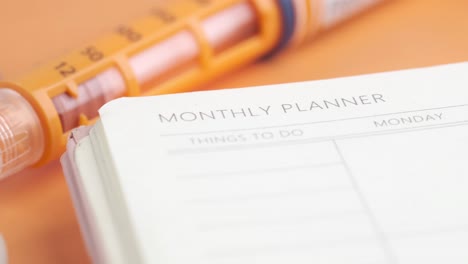 monthly planner and insulin pen