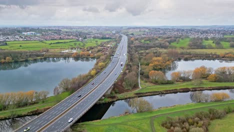 Aerial-drone-cinematic-video-footage-of-the-M1-Motorway-near-the-city-of-Wakefield,-West-Yorkshire,-UK