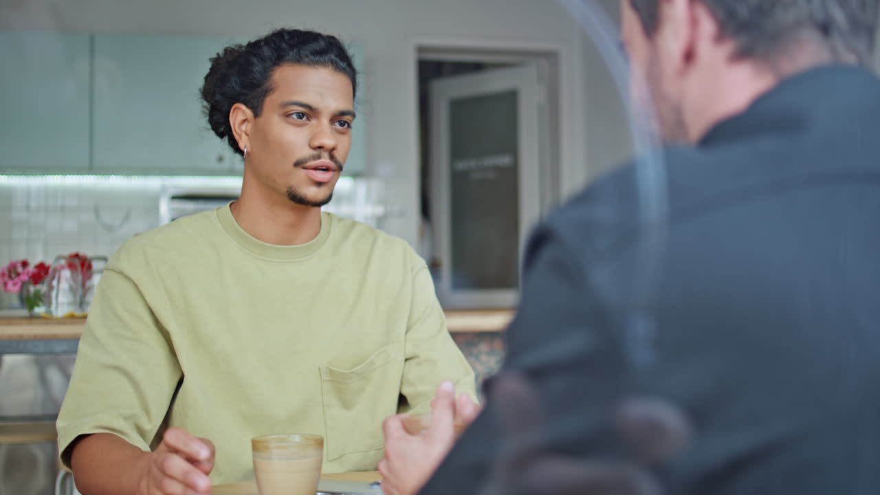 Two buddies talking coffee house sharing news close up. o guy with friend