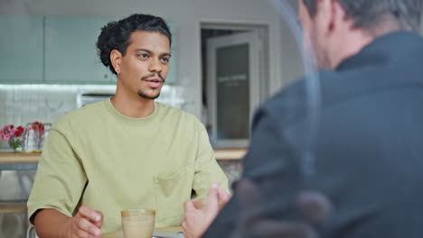 two buddies talking coffee house sharing news close up. o guy with friend