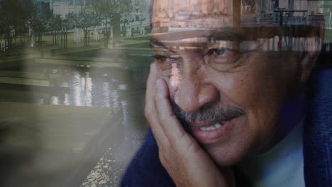 man with hand on face smiling in front of serene waterfront scene