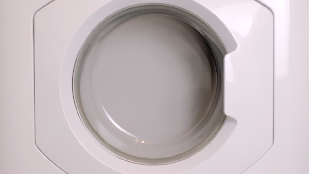 la lavadora lava diferentes ropas y sábanas. el cilindro gira. nadie