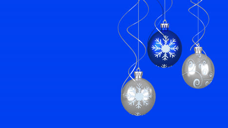 Animation-of-christmas-baubles-over-blue-background