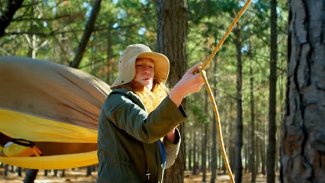 Woman-tying-hammock-in-the-forest-4k