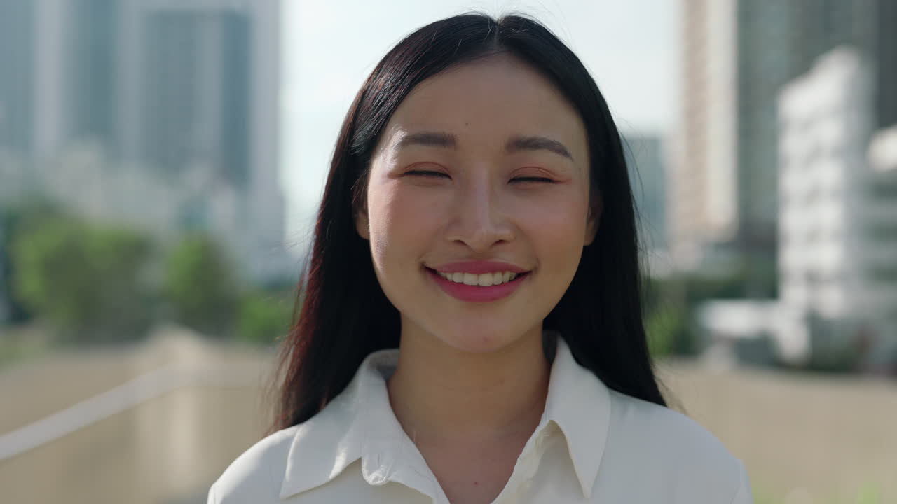Portrait of a Happy Young Asian Woman Smiling Outdoors in the City