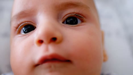 bare feet of cute little baby lying in the crib at home 4k