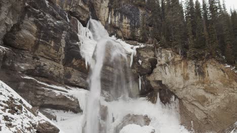 panther falls flowing on the nigel creek in the canadian rockies, british columbia, canada during winter