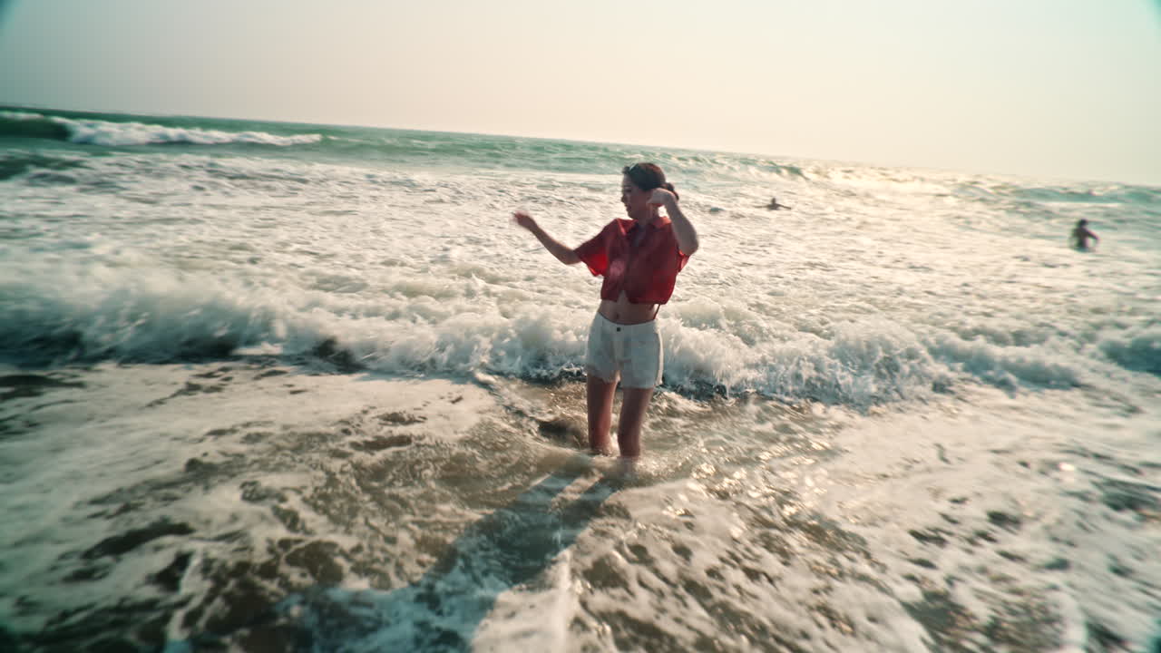 Woman enjoying the sea on the beach