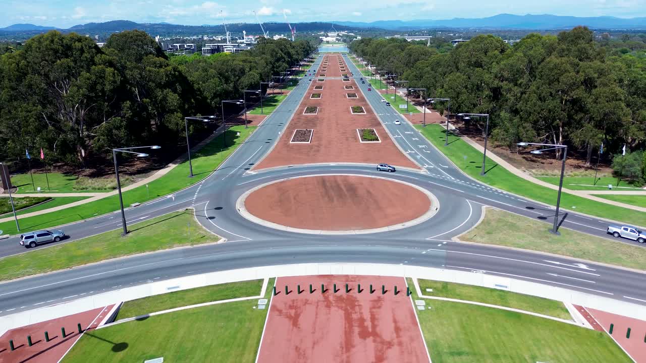 Drone aerial landscape of car vehicles traffic travelling on roundabout on main street road intersection highway courtyard of Anzac Parade War Memorial Canberra ACT Australia transport tourism