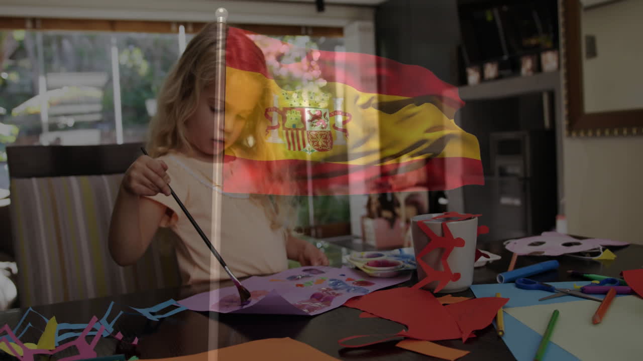 Crafting at table, child creating animation with Spanish flag overlay in school