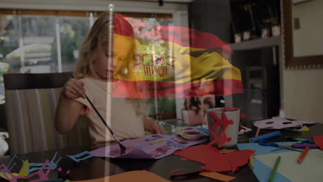 crafting at table, child creating animation with spanish flag overlay in school