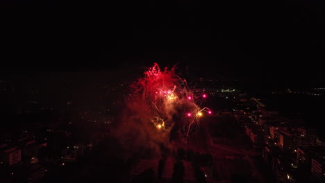 Soaring-above-Montpellier,-with-fireworks-painting-the-night-sky-in-dazzling-hue