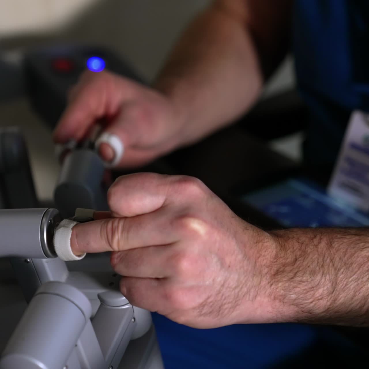 Doctor's hands manipulating the robotic arms of Da Vinci surgeon. Close up. Professional using technological equipment in operation