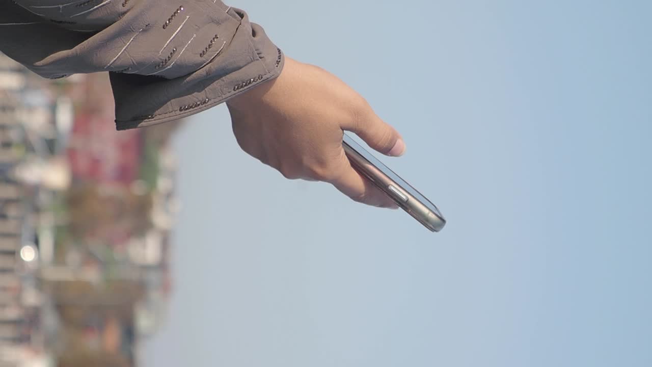 Hand holding a phone against the sky