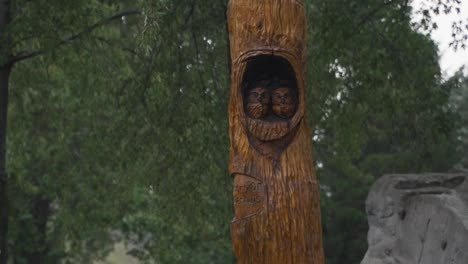 owl nest wood carving statue on an overcast evening before dusk at seims park in union, il