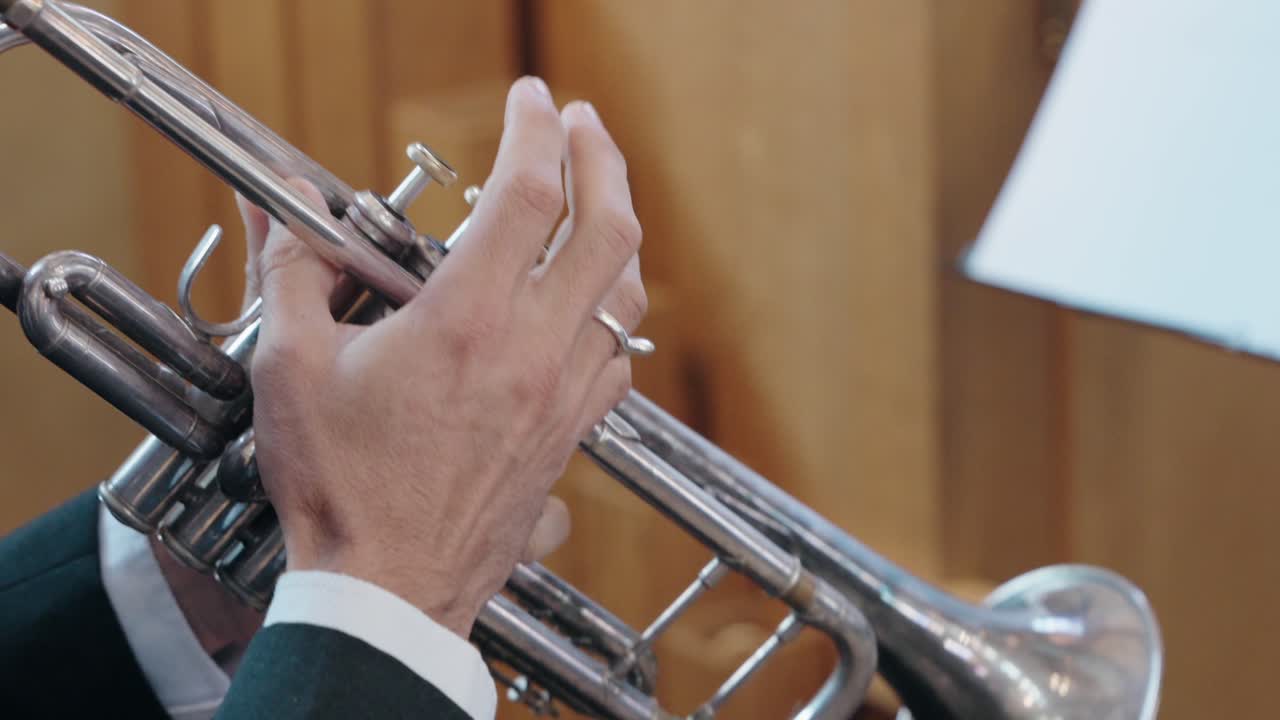 Close up of a trumpet player in formal attire performing during an event