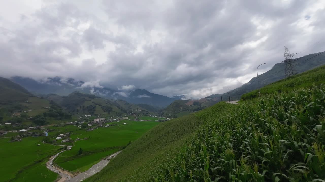 Timelapse of clouds moving over Scenic view of rice terraces and mountains in Sapa Vietnam with winding mountain road, lush green landscape and cultural travel destination in Southeast Asia