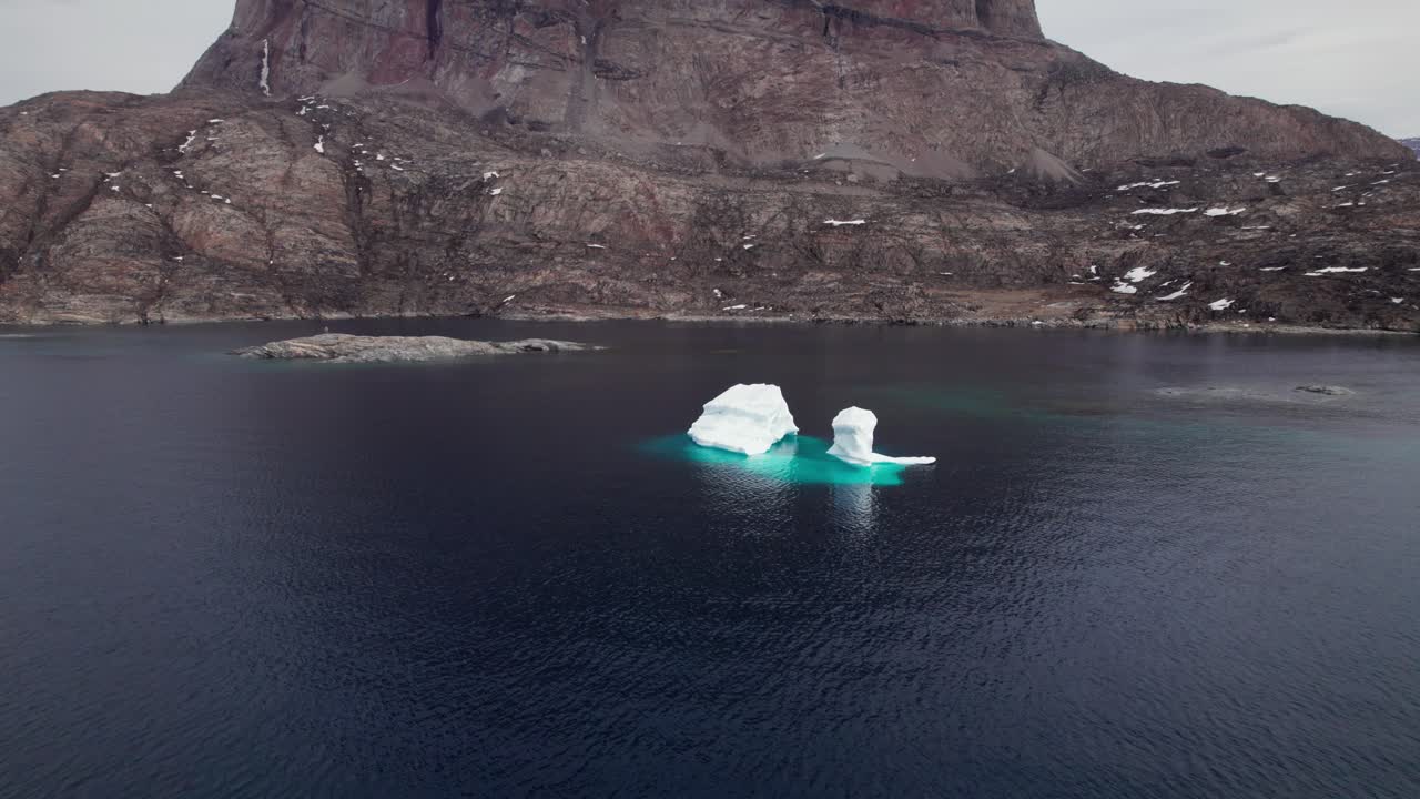 Melting Iceberg in the Arctic, Showcasing Climate Changes and Global Warming - Tilt Shot
