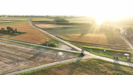 the drone shot shows a rural landscape where three roads meet at an intersection