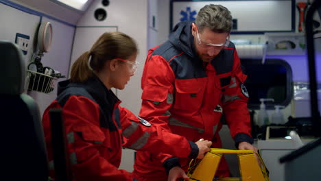 rescue team of paramedics preparing medical equipment