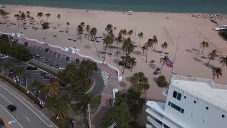 aerial view of a sandy beach with a palm trees in fort lauderdale florida, slider wide shot