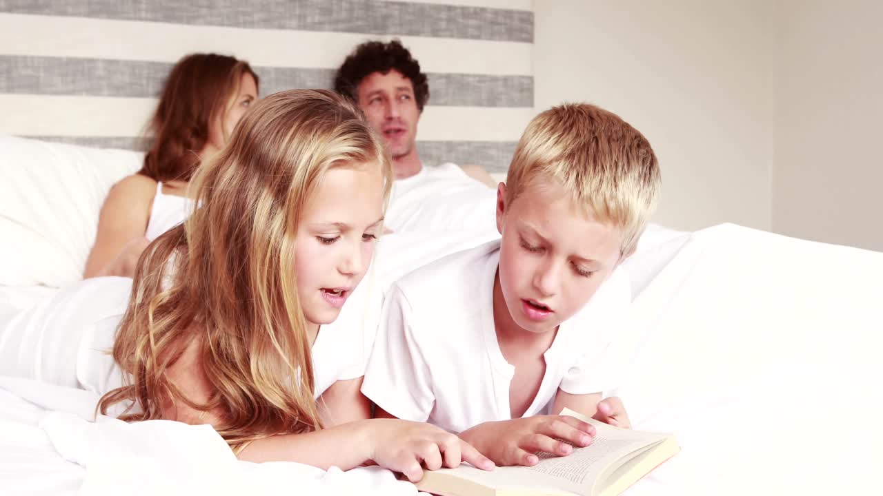 누나 들 이 침대 에 책 을 읽고 있다