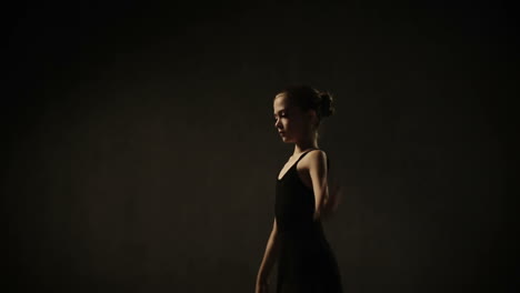 ballet dancer action. pretty young ballerina wearing a tutu in a dance studio