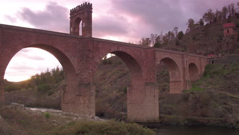 cinematic tracking shot of alcántara bridge at golden hour