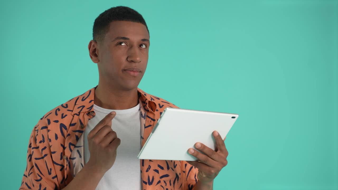 Pensive african american man using tablet
