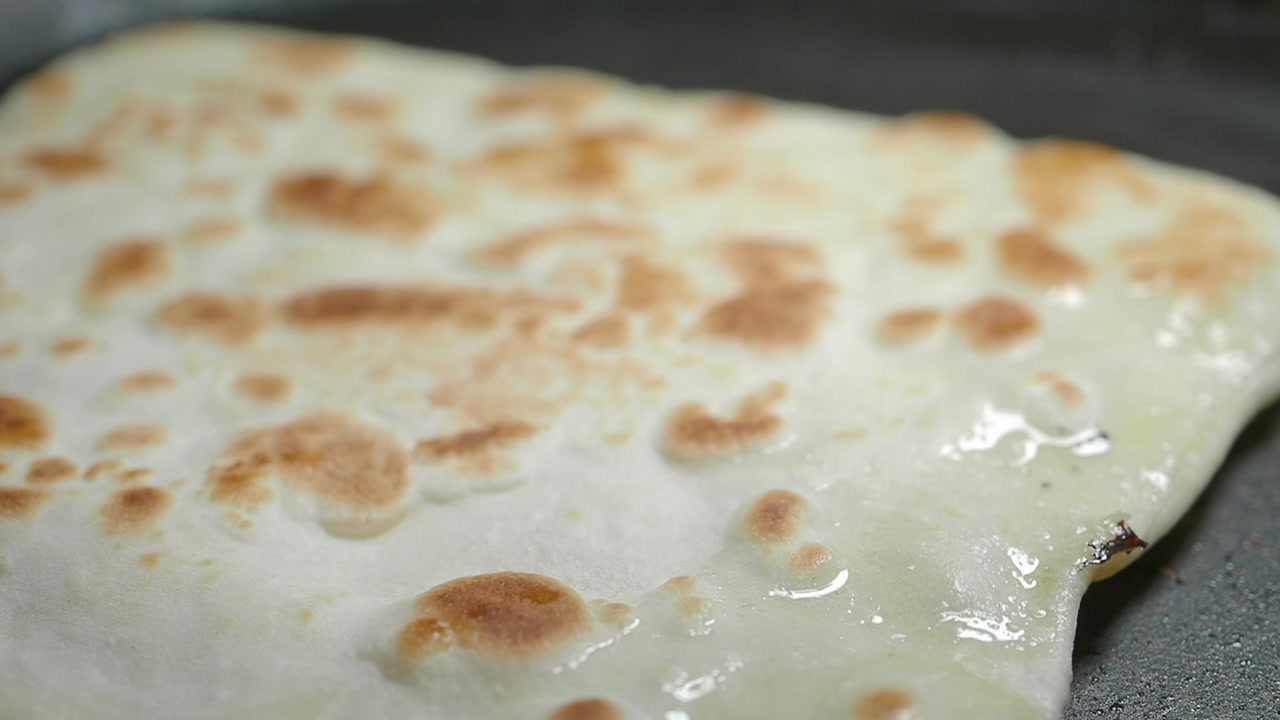 Close-Up of Cheese Flatbread Frying on a Hot Pan