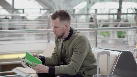 man using tablet at the airport