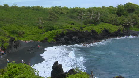 A-High-Angle-Shot-Over-Waves-Rolling-Into-A-Black-Sand-Beach-In-Hawaii