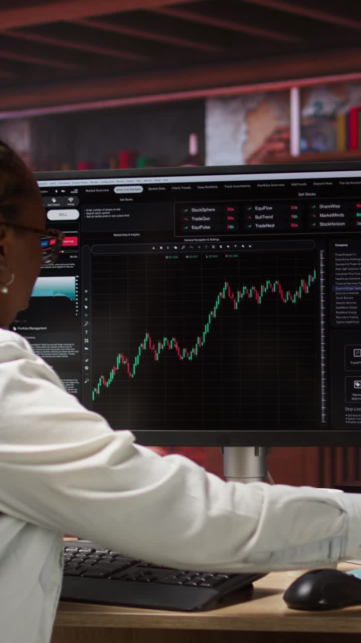 Vertical video Forex trader browsing though stock exchange portfolio pages at computer desk