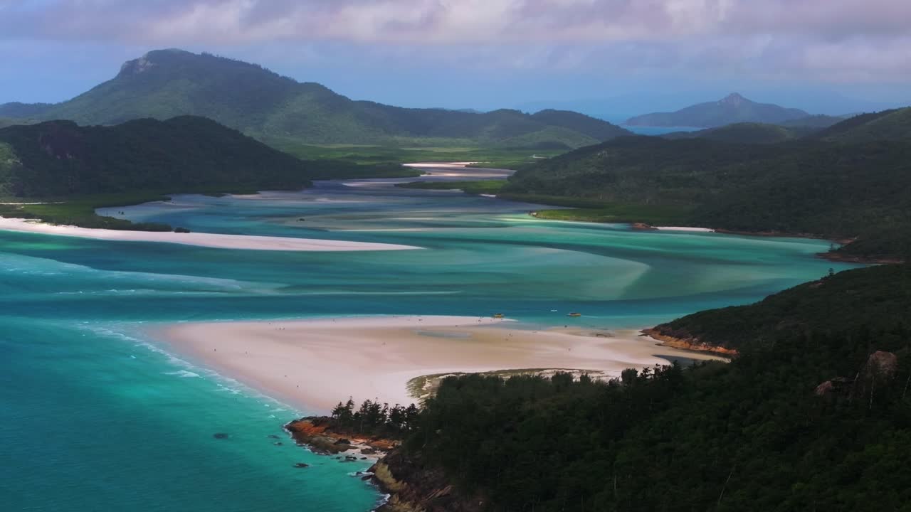 Picturesque Hill Inlet Lookout aerial drone view Whitsundays Island Whitehaven Beach North end cloudy sunny summer spring autumn scenic flight tourist clear blue waters sandy National Park static shot