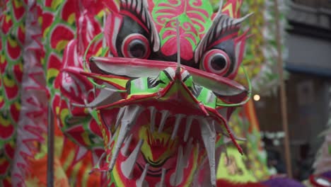 close view of beautiful head of chinese dragon during new year celebration parade in china town london england