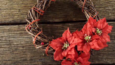 Grapevine-wreath-with-flowers-on-wooden-table-4k