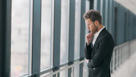 An-excited-man-in-anticipation-receives-a-joyful-message-on-his-smartphone