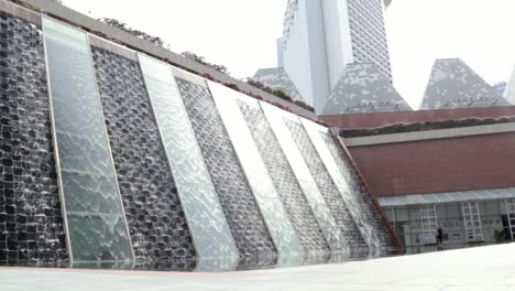 standing shot of a beautiful water feature at the millenia tower in singapore