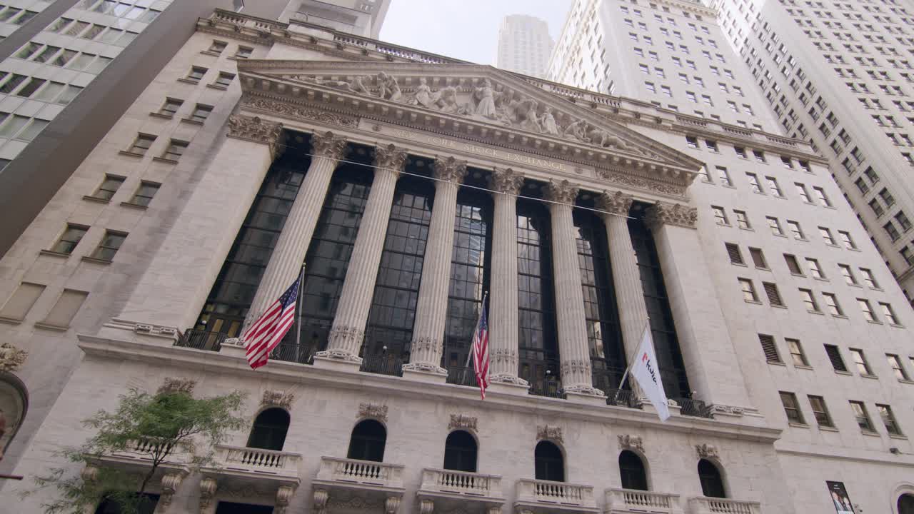 New York Stock Exchange building with flags in lower Manhattan during the day, wide angle shot
