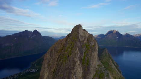 aerial close up view from the mountain peak segla on senja in northern norway, ascending orbit shot